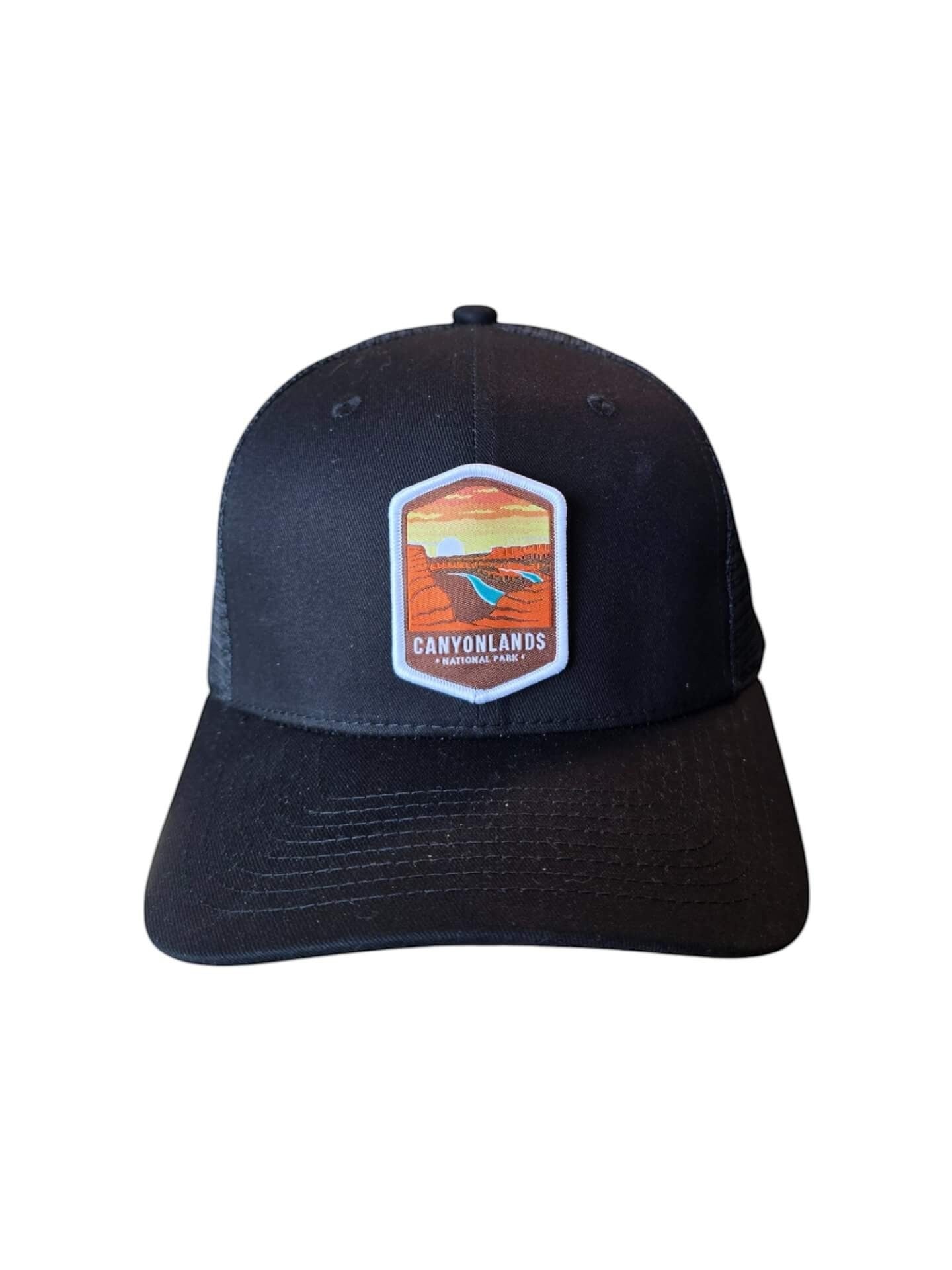 Moove Headwear black trucker hat with Canyonlands National Park emblem, mesh back, and adjustable snap closure.