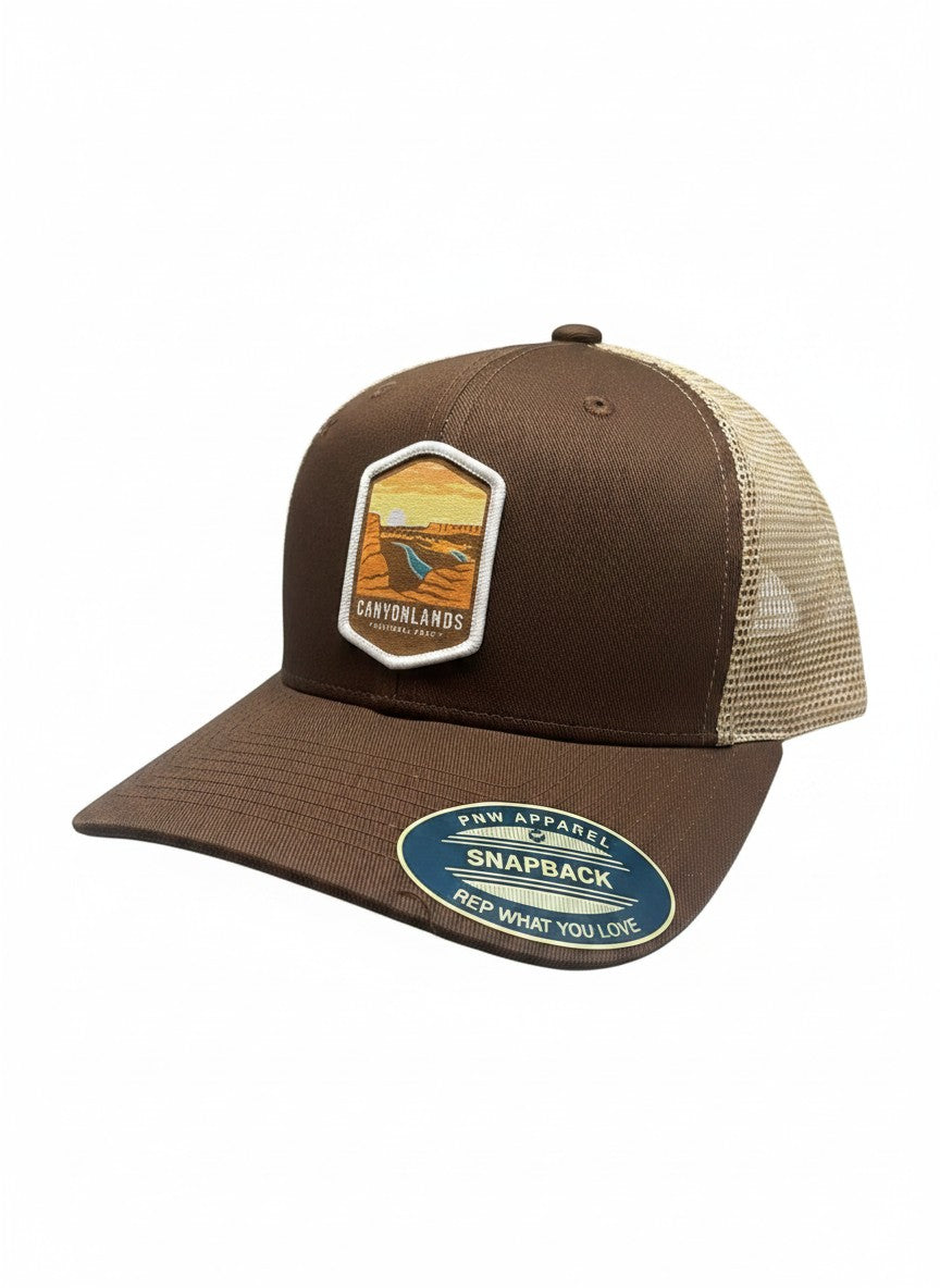 Moove Headwear brown trucker hat with mesh back and Canyonlands National Park emblem. Adjustable snap closure.