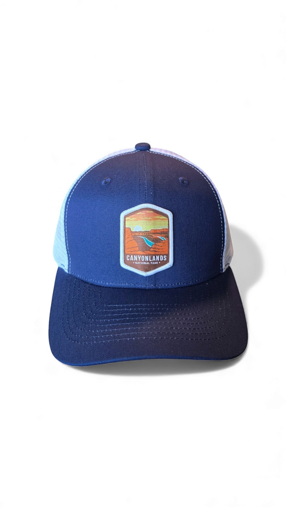 Moove Headwear navy blue trucker hat with white mesh back and Canyonlands National Park emblem.