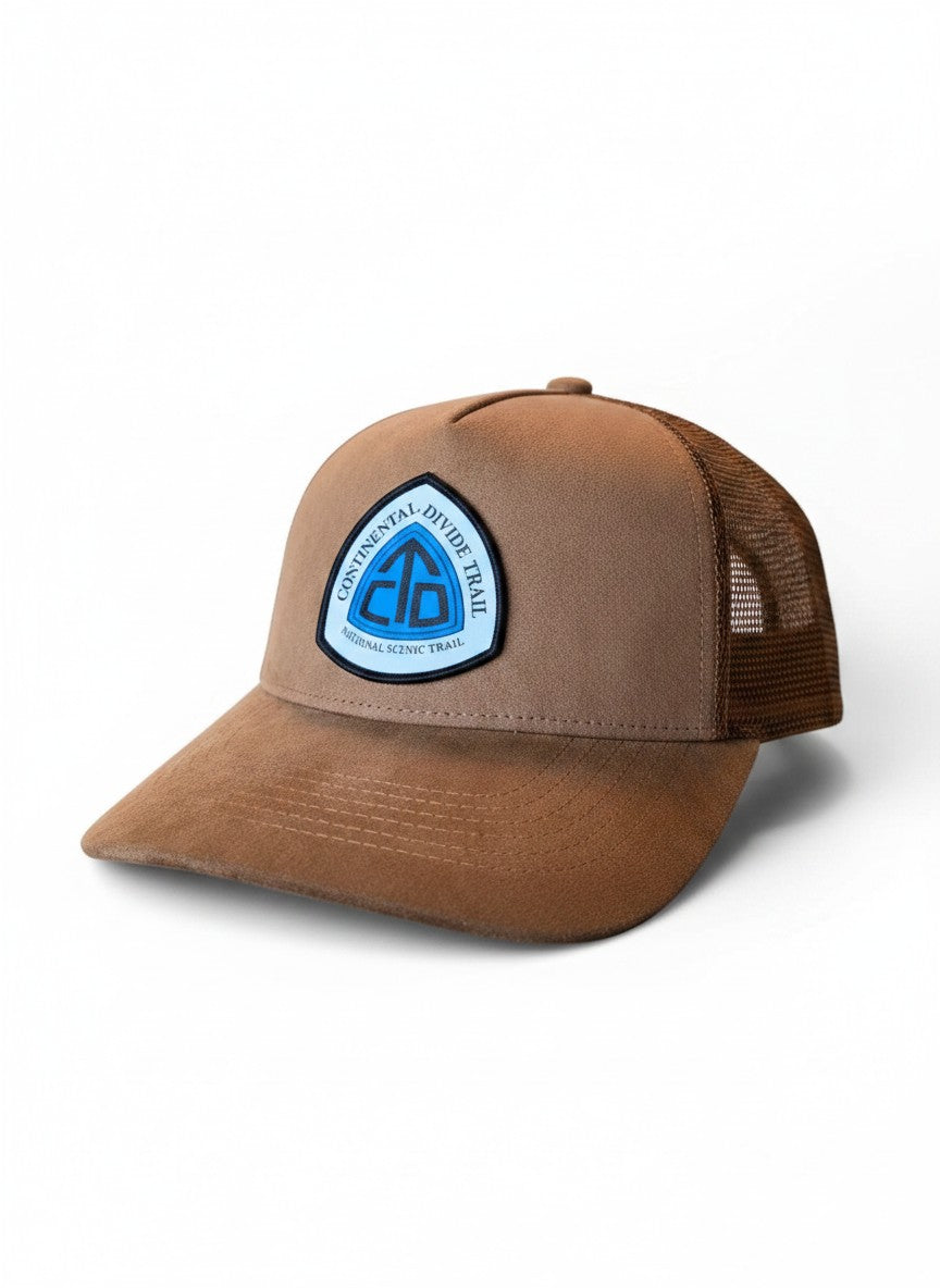 Moove Headwear brown suede trucker hat with mesh back and Continental Divide Trail patch. Adjustable snapback.