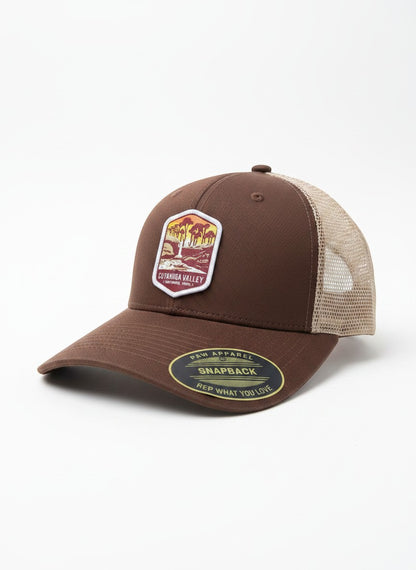 Moove Headwear brown trucker hat with Cuyahoga Valley National Park embroidered patch and breathable mesh back.