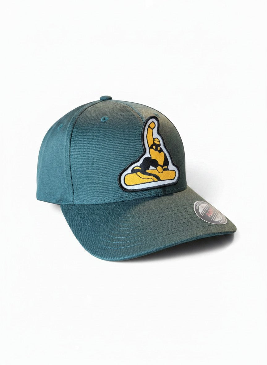 Moove Headwear dark green fitted cap with a yellow and black snowboarder patch. Features a structured crown and Flexfit logo.
