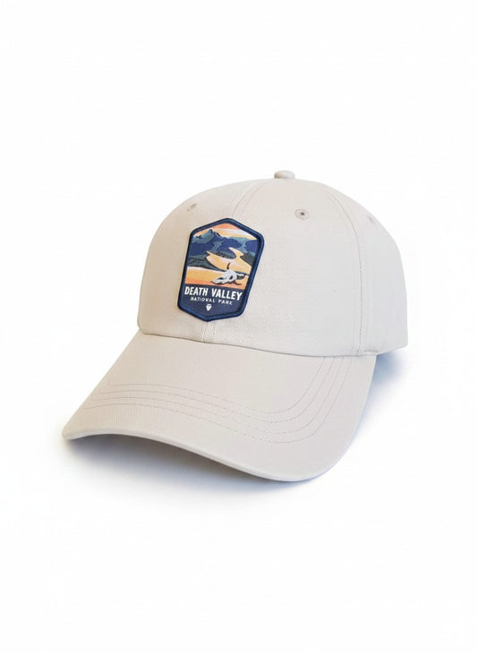 Moove Headwear Death Valley National Park baseball cap in beige with a woven patch depicting mountains and desert landscape.