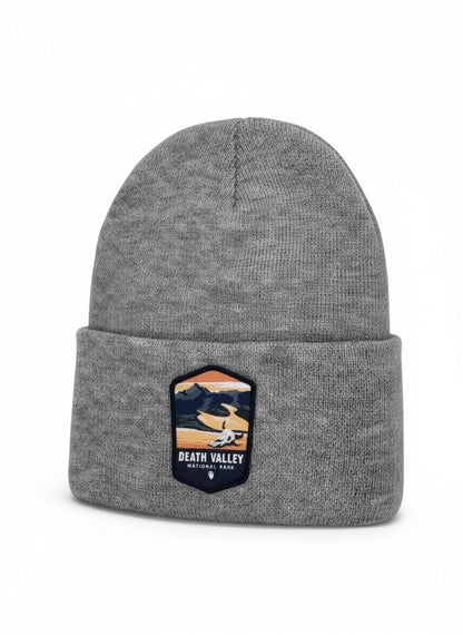 Moove Headwear grey knit beanie with a Death Valley National Park patch featuring mountains and a desert landscape.
