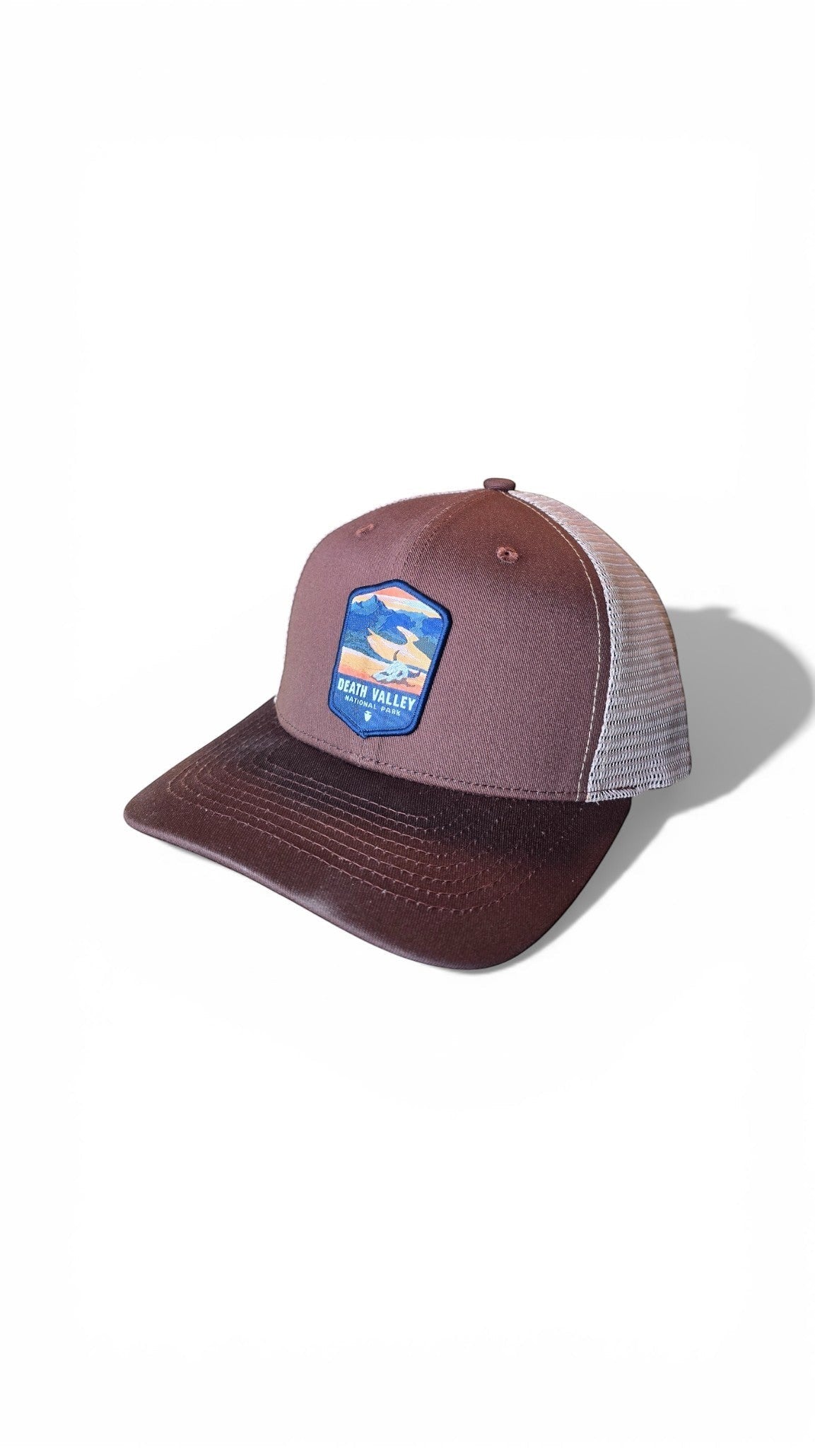 Moove Headwear brown trucker hat with breathable mesh back and Death Valley National Park patch. Adjustable snapback.