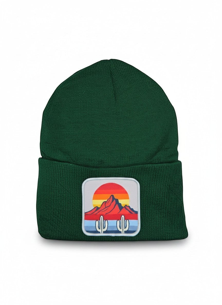 Moove Headwear dark green knit beanie with a desert sunset cactus patch. Features a ribbed cuff.