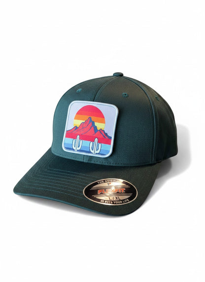 Moove Headwear dark green fitted hat with cactus and mountain sunset patch. Mid-profile structured crown, Flexfit.