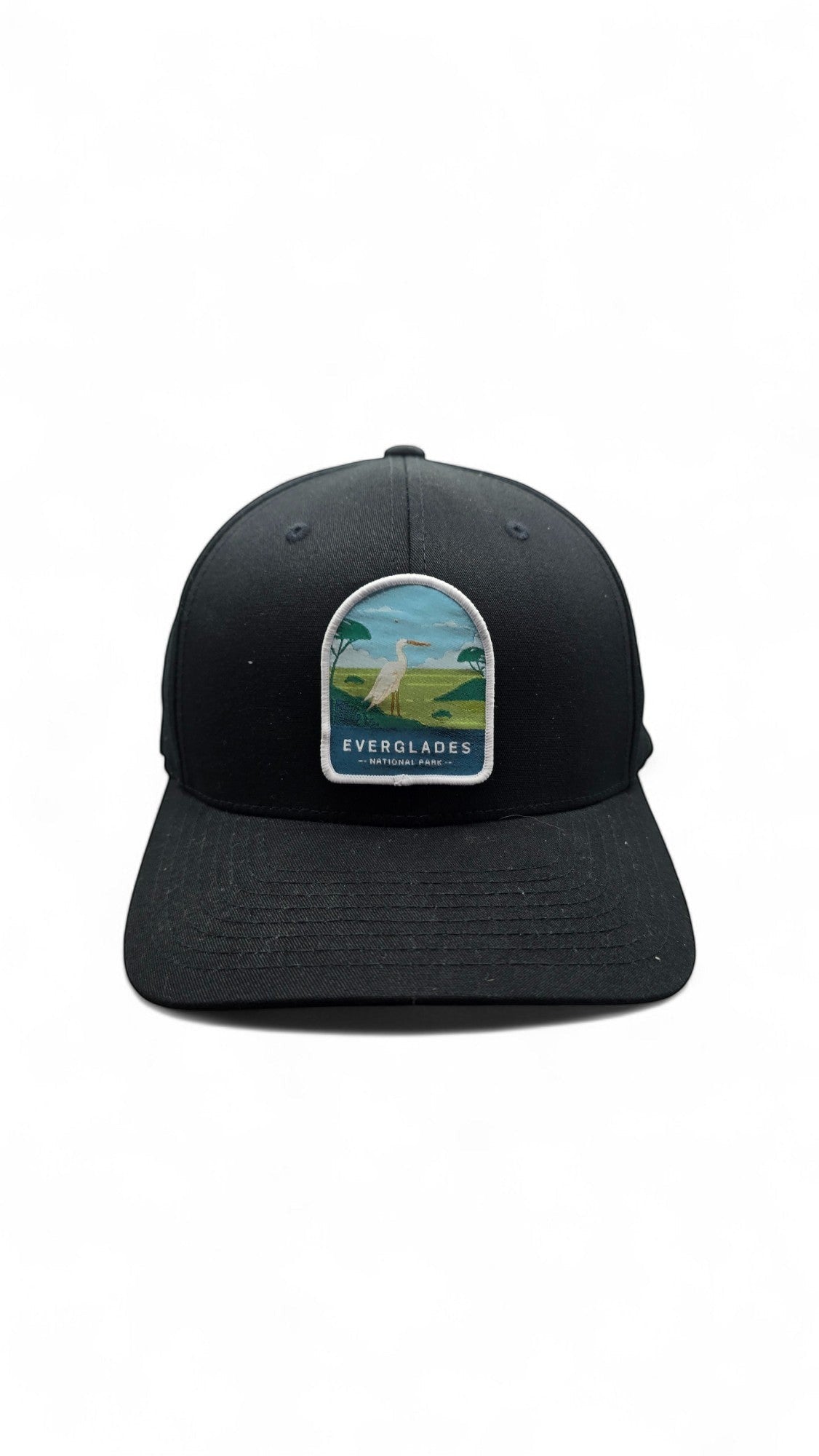 Moove Headwear black fitted hat with embroidered Everglades National Park patch featuring a white egret and palm trees.
