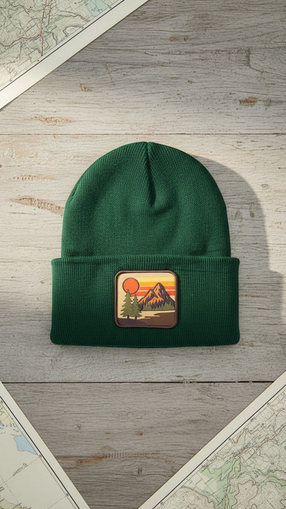 Moove Headwear forest green knit beanie with vintage mountain sunset patch. Unisex fit, one size fits most.