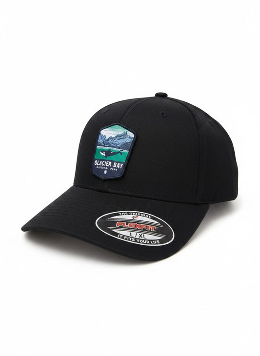 Moove Headwear black fitted hat with Glacier Bay National Park patch featuring a whale and mountains. Acrylic, cotton, PU spandex.