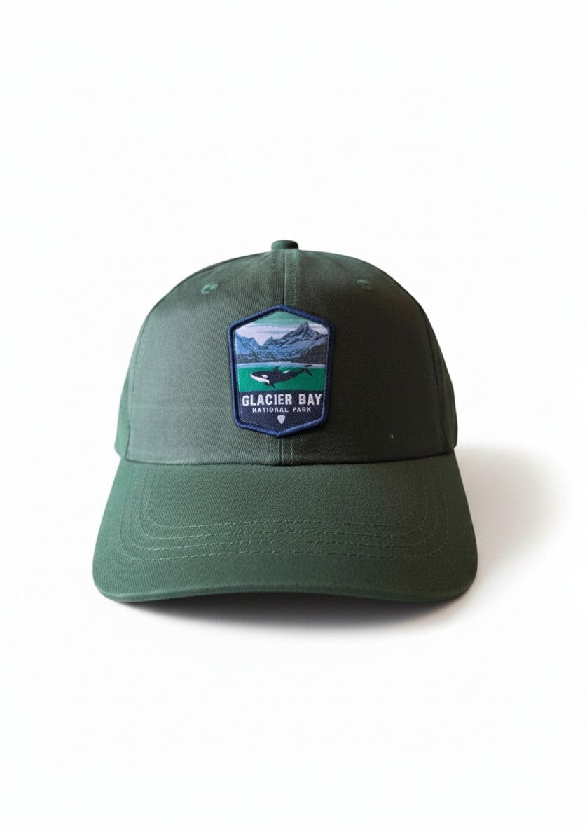 Moove Headwear dark green dad hat with Glacier Bay National Park whale and mountain embroidered patch.