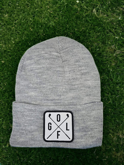 Moove Headwear grey acrylic knit beanie with a white square patch featuring crossed golf clubs and the word GOLF.