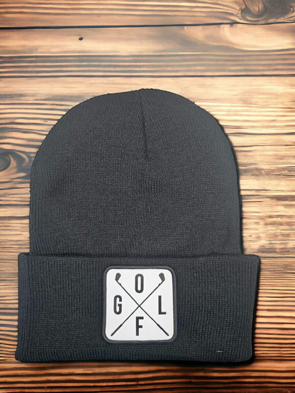 Moove Headwear dark grey acrylic knit beanie with a white square patch featuring crossed golf clubs and the word GOLF.