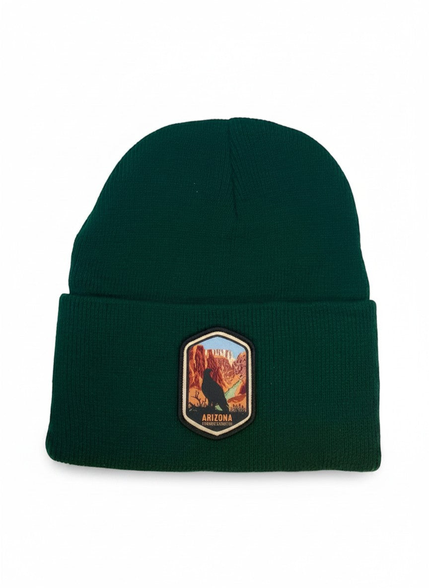 Moove Headwear dark green acrylic rib-knit beanie with a woven patch featuring a bird and the Grand Canyon.