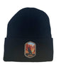 Moove Headwear black acrylic rib-knit beanie with a woven patch featuring a bird silhouette against the Grand Canyon landscape.