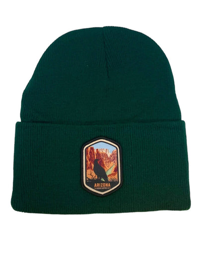 Moove Headwear dark green acrylic rib-knit beanie with a woven patch depicting the Grand Canyon and a bird.