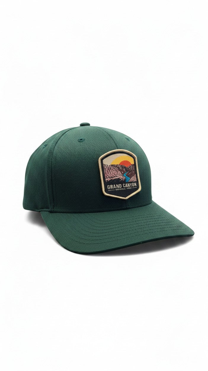Moove Headwear dark green Flexfit baseball cap with embroidered Grand Canyon patch and sunset graphic.