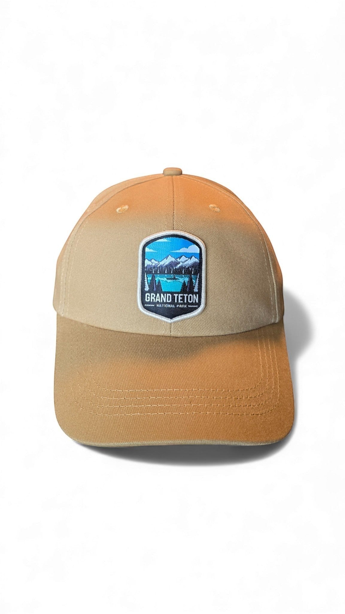 Moove Headwear tan cotton dad hat with Grand Teton National Park embroidered patch and adjustable strap.