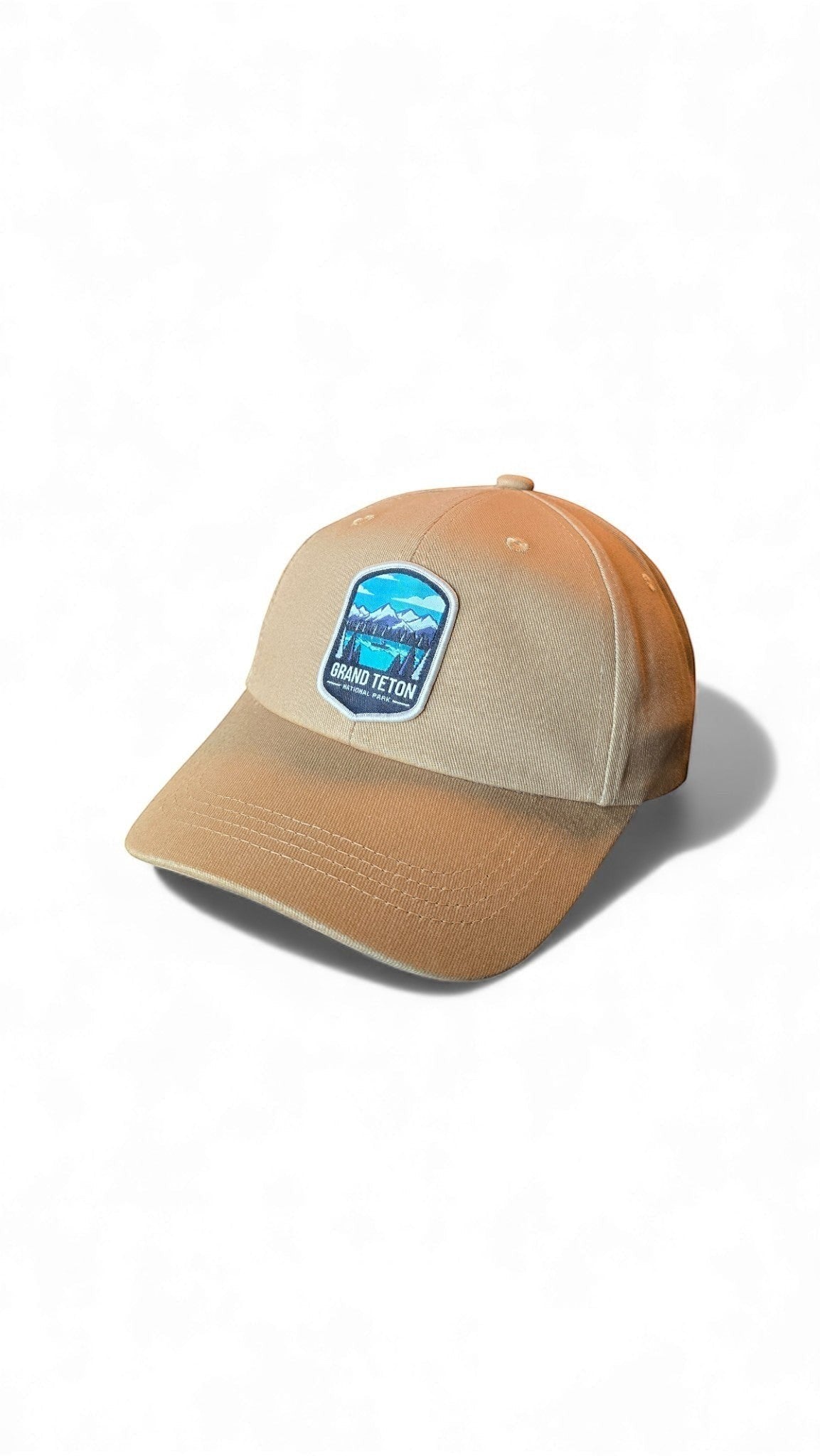Moove Headwear tan cotton dad hat with Grand Teton National Park embroidered patch and adjustable strap.