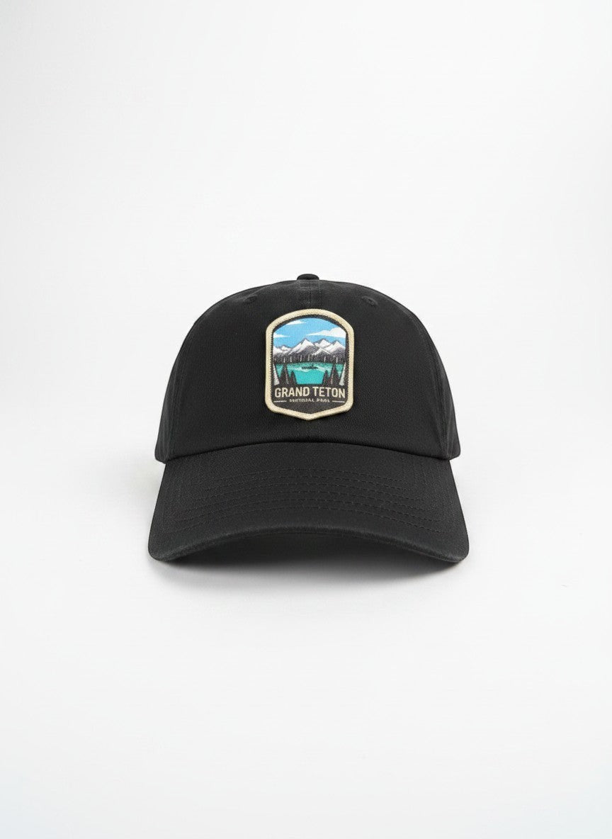 Moove Headwear black cotton dad hat with embroidered Grand Teton National Park patch and adjustable strap.
