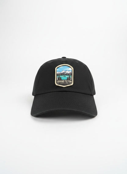 Moove Headwear black cotton dad hat with embroidered Grand Teton National Park patch and adjustable strap.