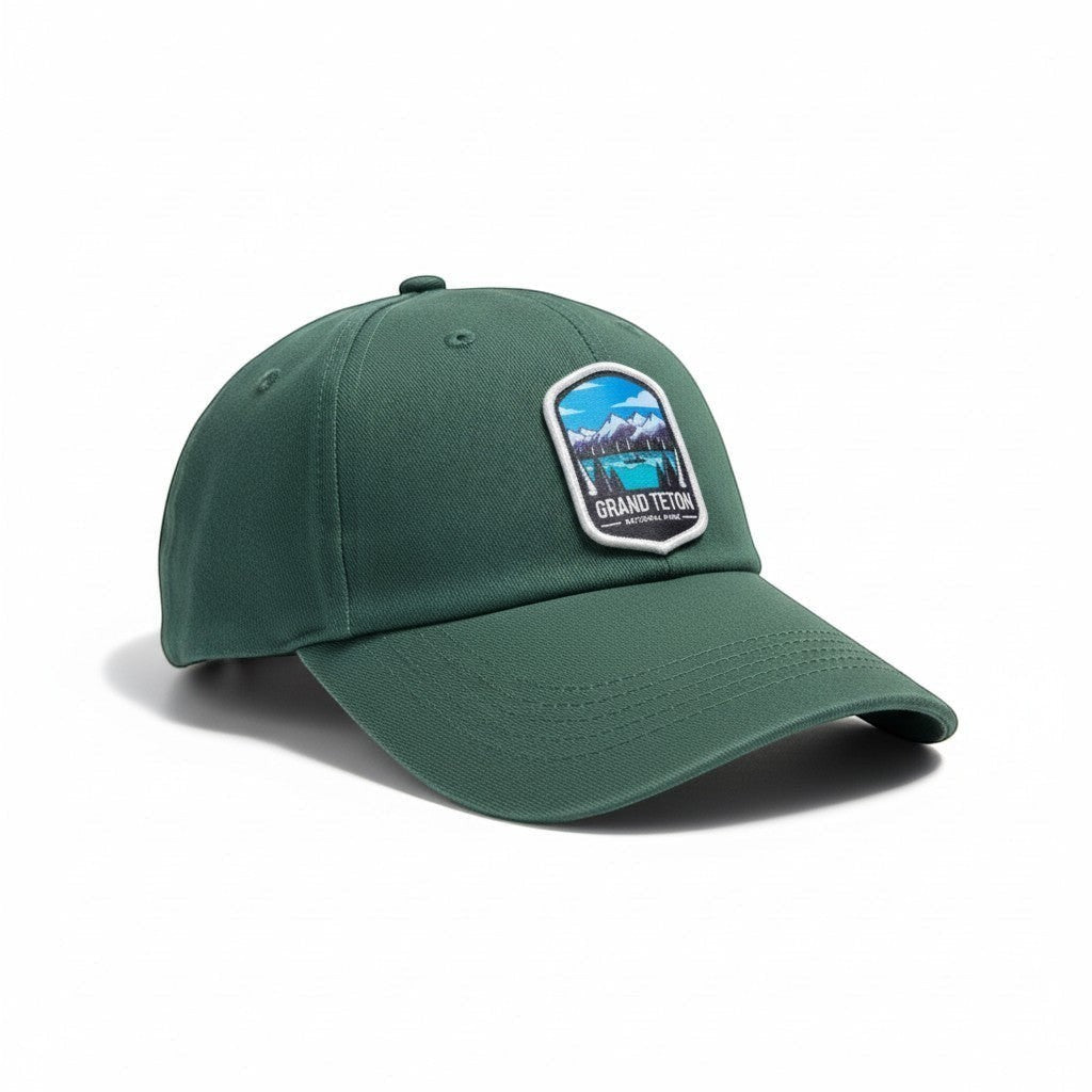 Moove Headwear green cotton dad hat with Grand Teton National Park embroidered patch and adjustable strap.