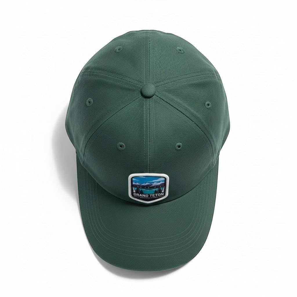 Moove Headwear dark green cotton dad hat with Grand Teton embroidered patch and adjustable strap.