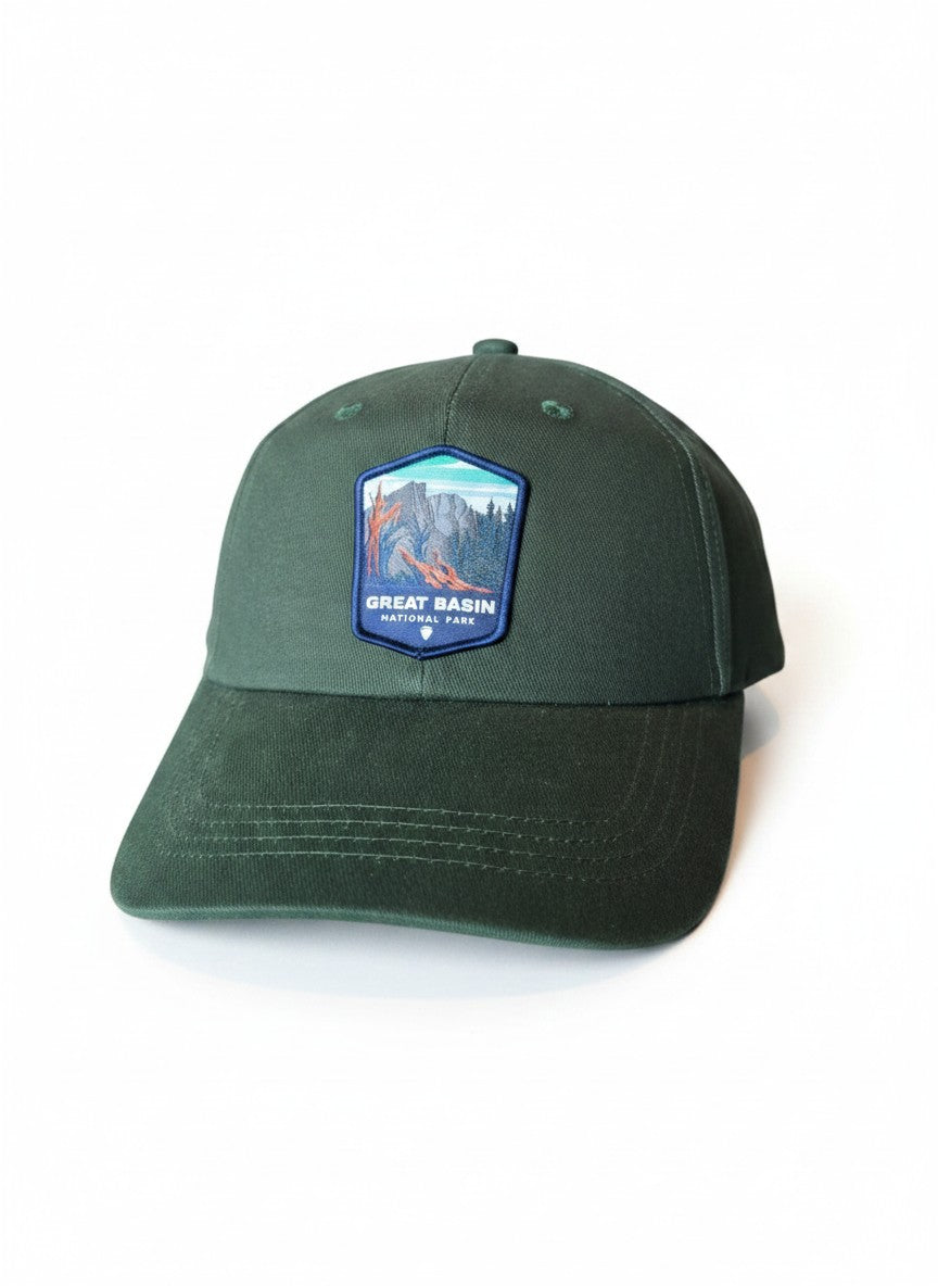 Moove Headwear Great Basin National Park dark green trucker hat with embroidered mountain landscape patch and adjustable closure.