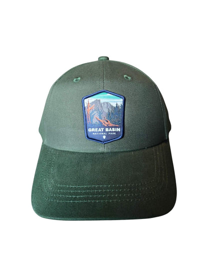 Moove Headwear Great Basin National Park dark green trucker hat with woven mountain patch and adjustable closure.