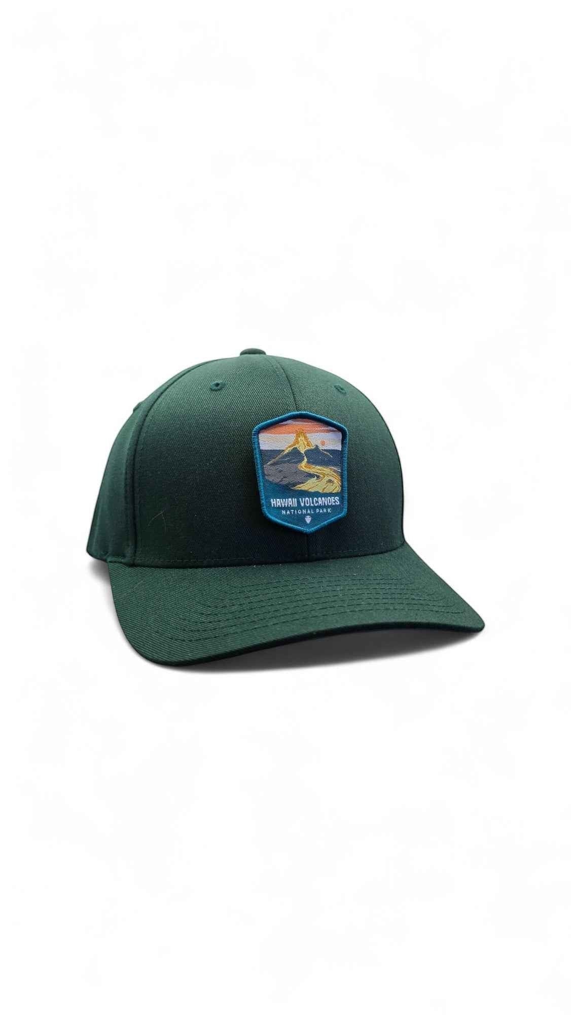 Moove Headwear green fitted cap with embroidered Hawaii Volcanoes National Park patch featuring a lava and sunset scene.