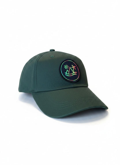 Moove Headwear dark green low profile cap with adjustable brass buckle and hook and loop closure, featuring a circular patch with a mountain and palm tree.