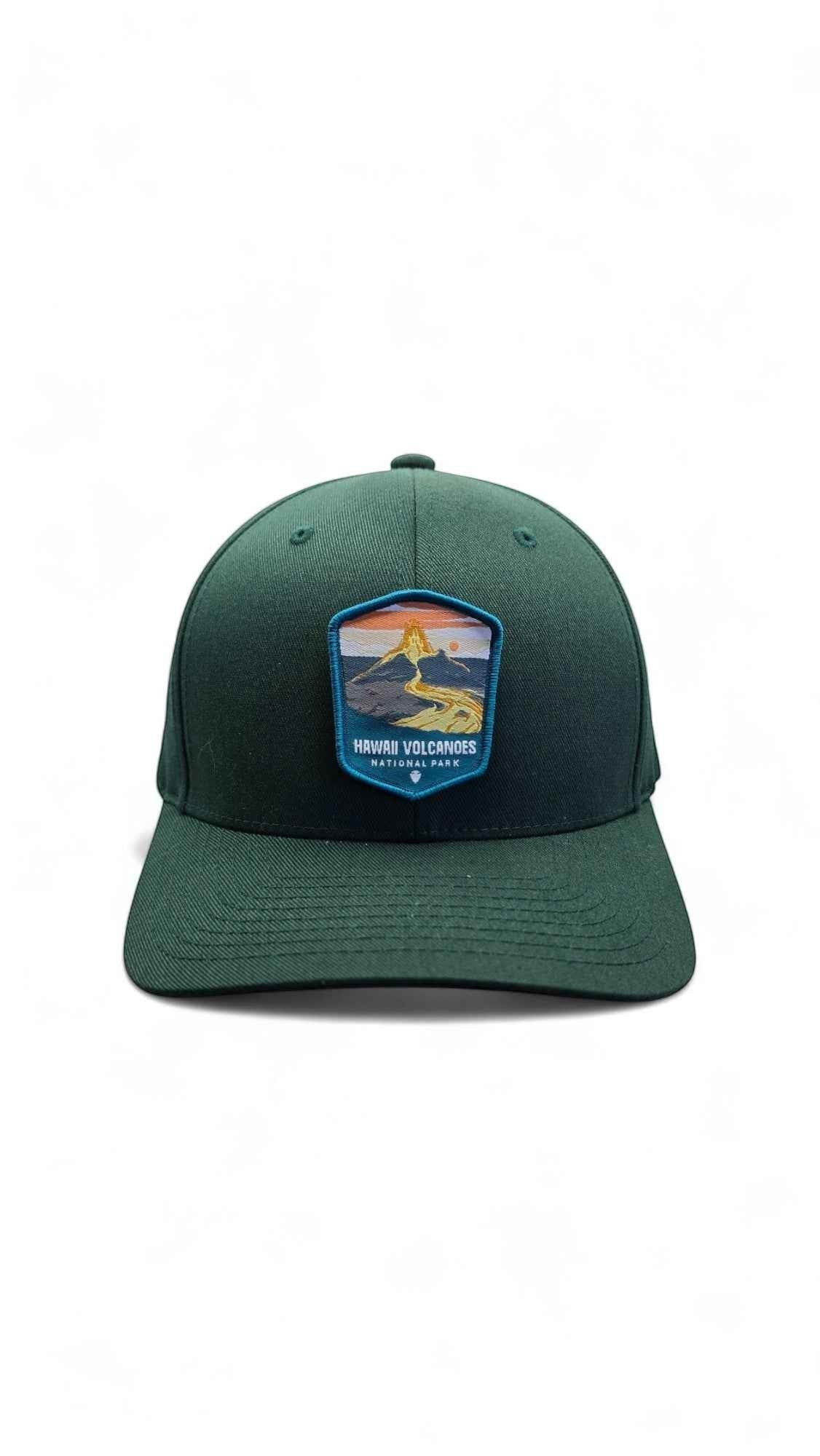 Moove Headwear deep green fitted cap with embroidered Hawaii Volcanoes National Park patch featuring a lava and sunset scene.