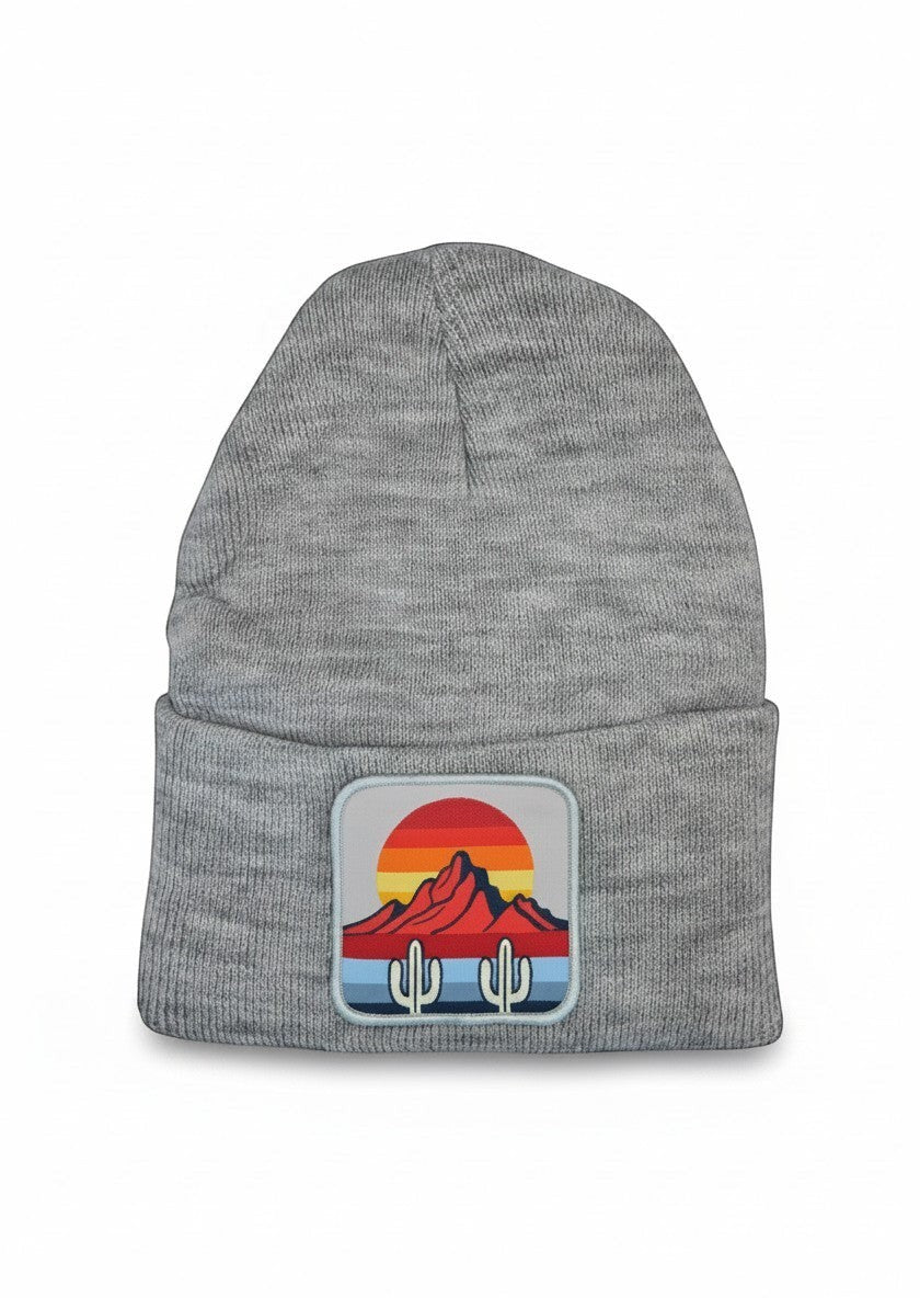 Moove Headwear grey knit beanie featuring a desert sunset and cactus patch on the front cuff.