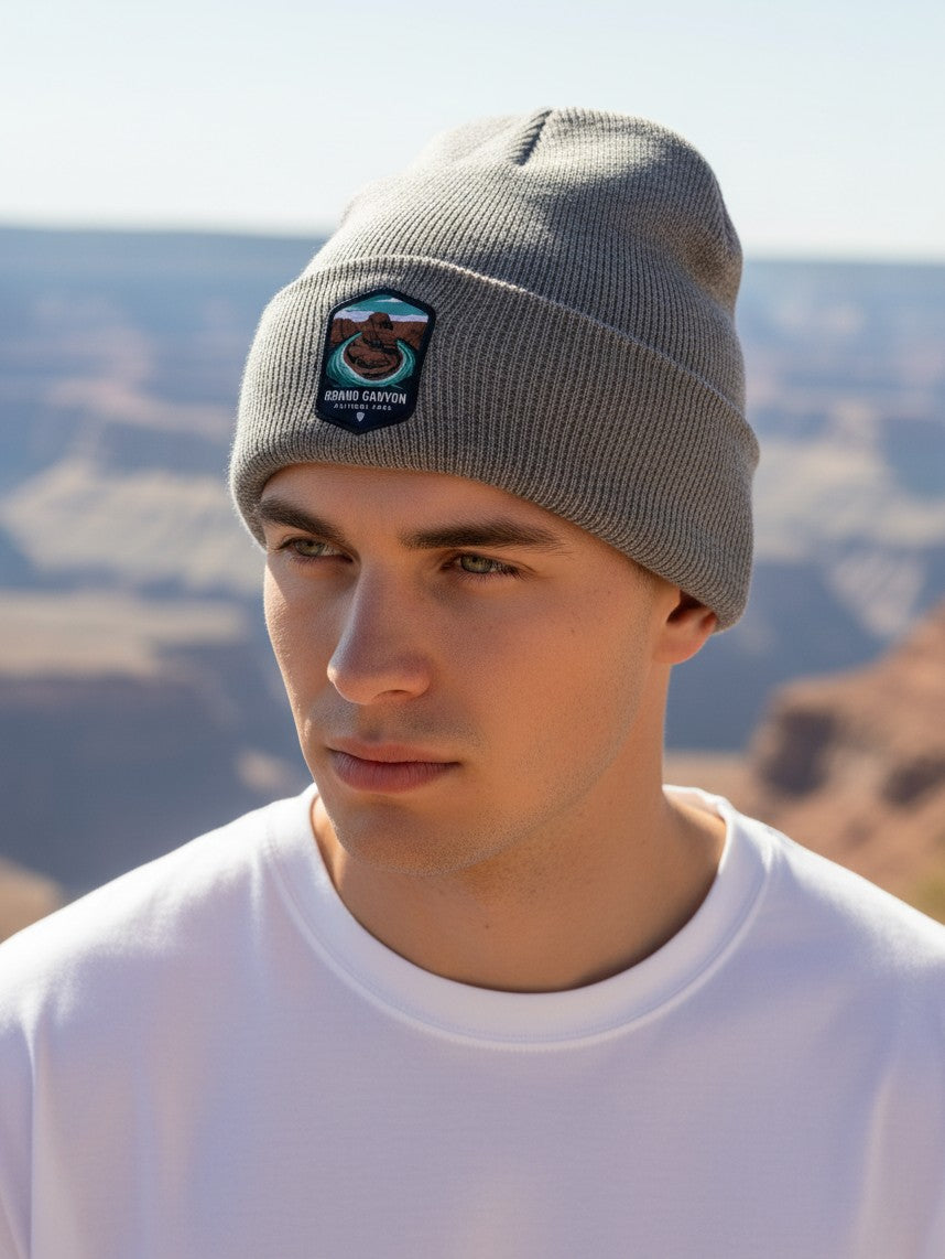 Moove Headwear grey rib-knit beanie with a Grand Canyon National Park embroidered patch worn by a man outdoors.