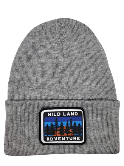 Moove Headwear grey knit beanie with a Wild Land Adventure patch featuring a forest landscape design.