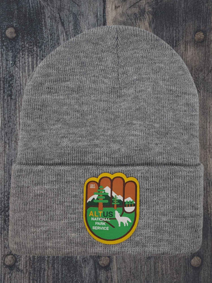 Moove Headwear grey cuffed knit beanie with AltUs National Park patch featuring a wolf and mountain design