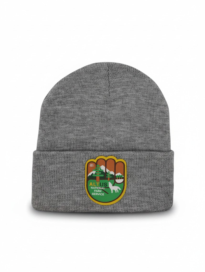 Moove Headwear grey cuffed knit beanie with an AltUs National Park patch featuring a wolf and forest landscape.
