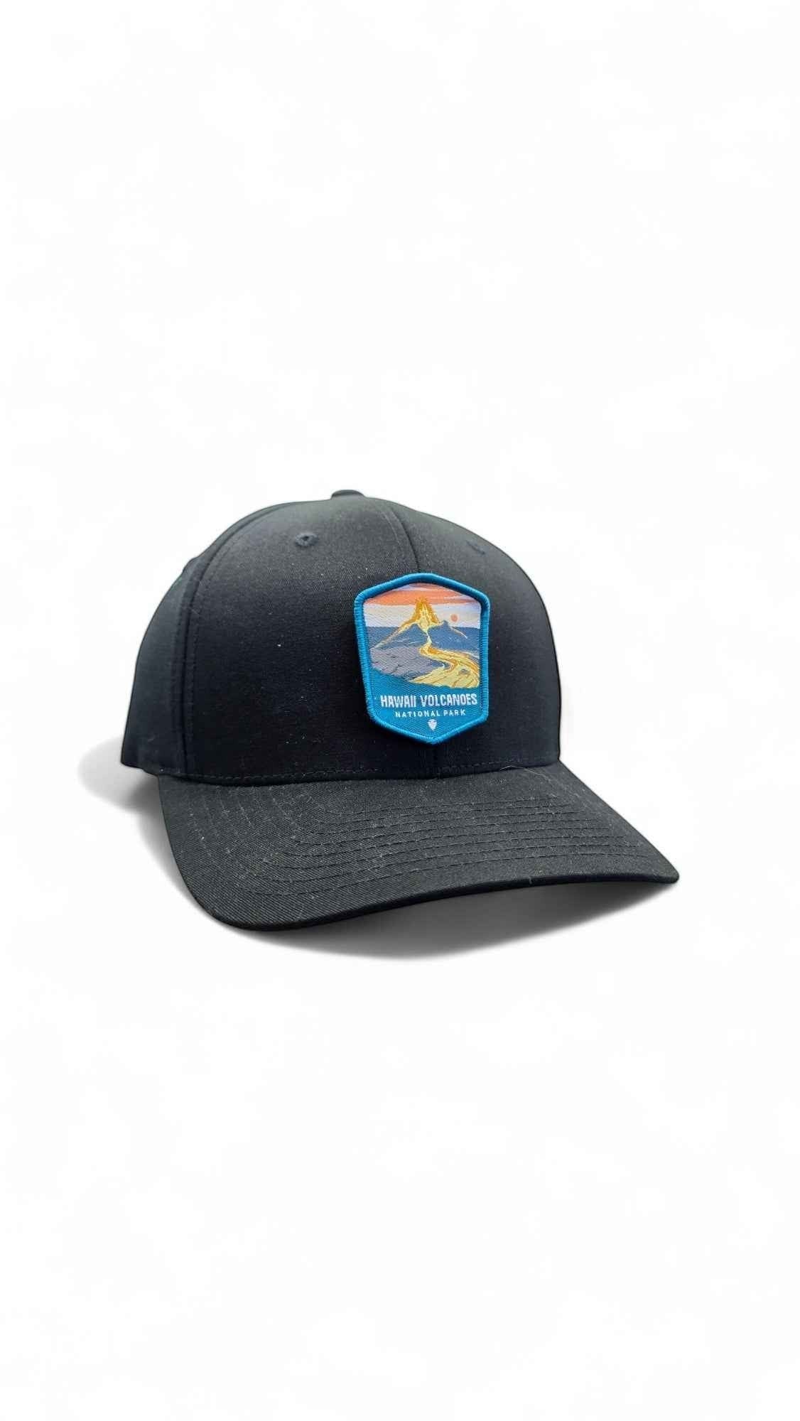 Moove Headwear black fitted cap with embroidered Hawaii Volcanoes National Park patch featuring a volcano and sunset.