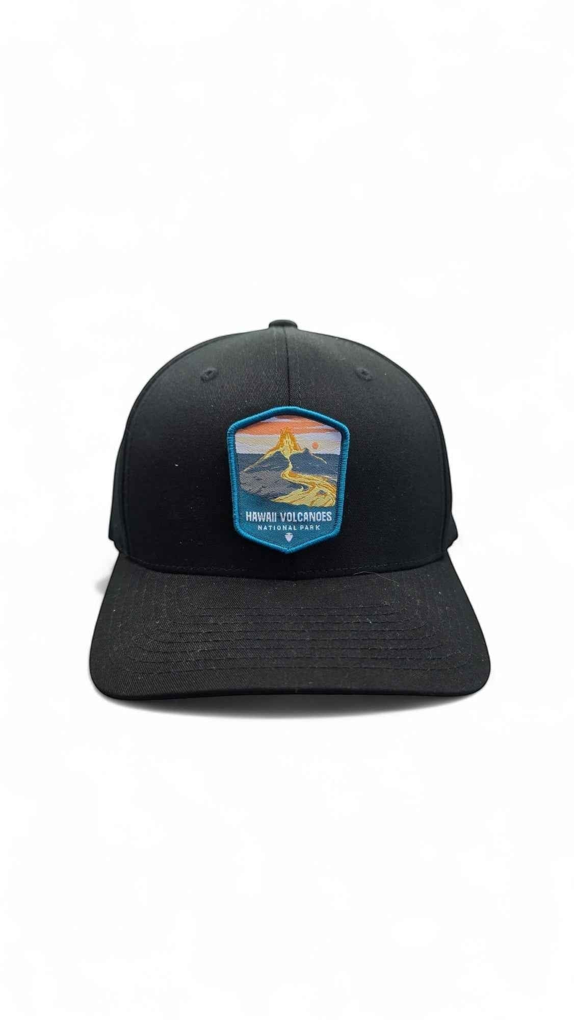 Moove Headwear black fitted cap with embroidered Hawaii Volcanoes National Park patch featuring a volcano and sunset.