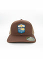 Moove Headwear brown trucker hat with Hawaii Volcanoes National Park logo patch and tan mesh back. Adjustable strap.