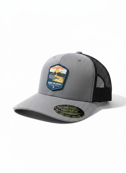 Moove Headwear grey trucker hat with Hawaii Volcanoes National Park logo patch and black mesh back. Adjustable strap.