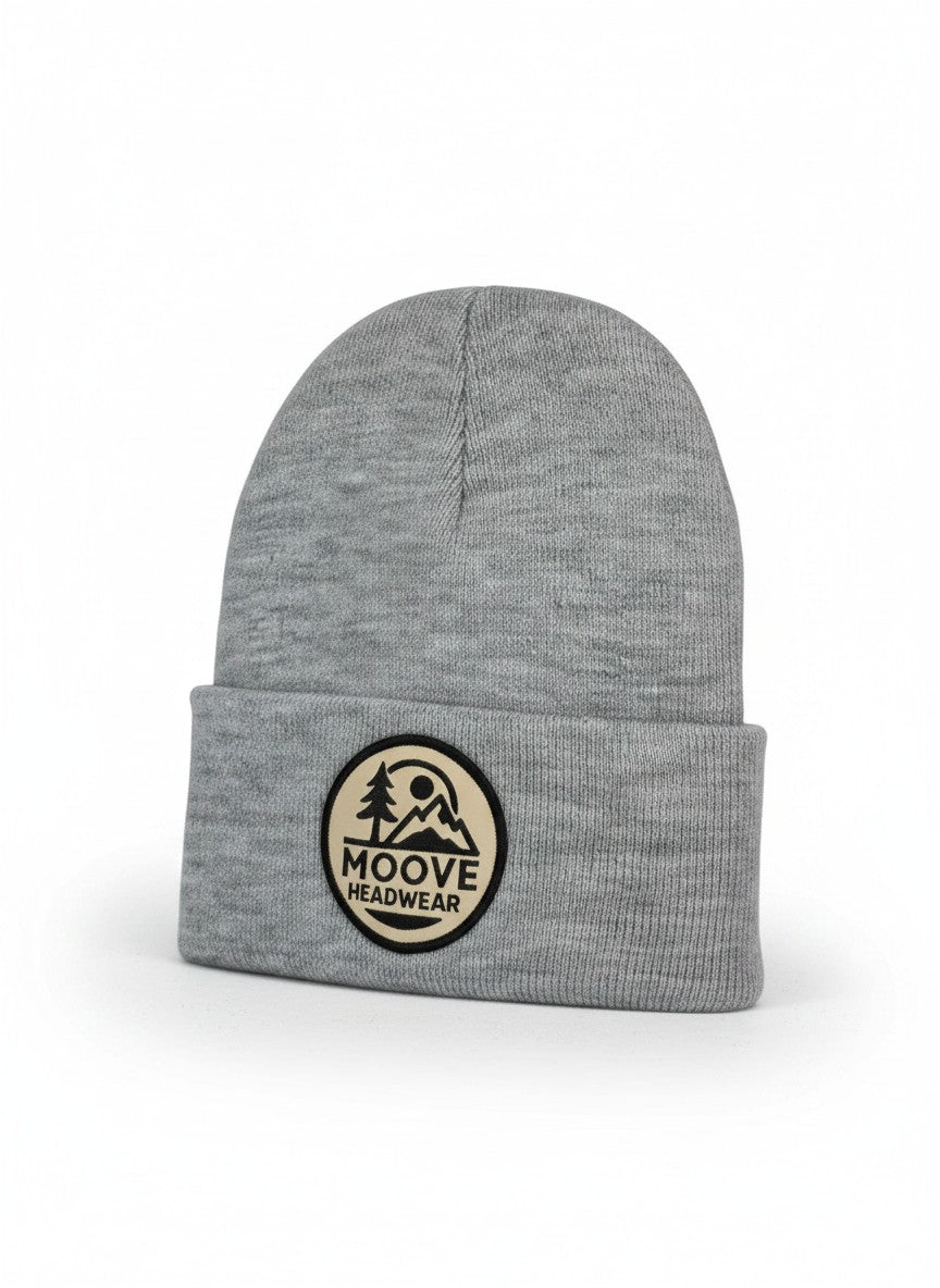 Moove Headwear heather gray knit beanie with fold-over cuff and circular mountain logo patch.