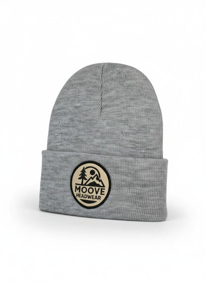 Moove Headwear heather gray knit beanie with fold-over cuff and circular mountain logo patch.