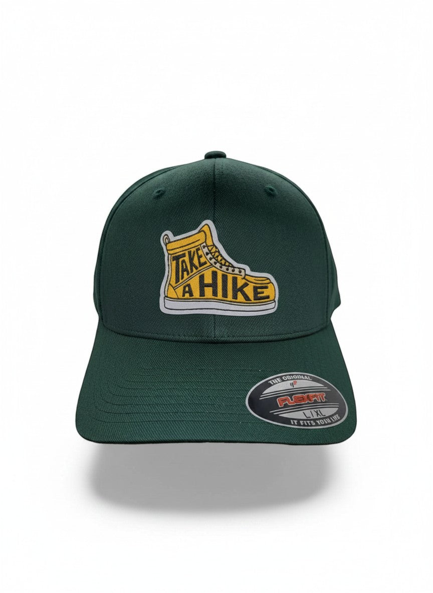 Moove Headwear dark green acrylic blend baseball cap with "Take a Hike" boot graphic and Flexfit logo.