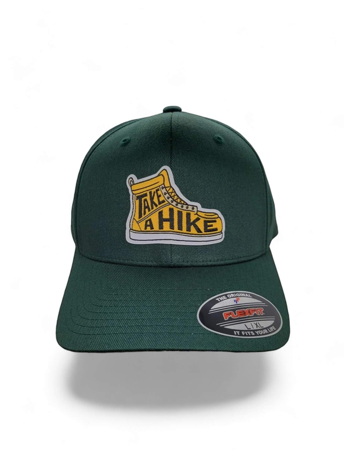 Moove Headwear dark green acrylic blend baseball cap with "Take a Hike" boot graphic and Flexfit logo.