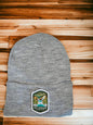 Moove Headwear grey acrylic rib-knit beanie with Hot Springs National Park embroidered patch on front.