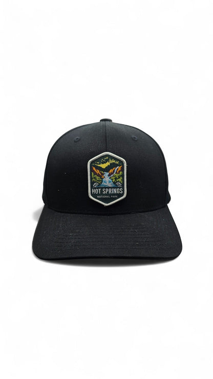 Moove Headwear black fitted baseball cap with Hot Springs National Park embroidered patch featuring a waterfall and trees.
