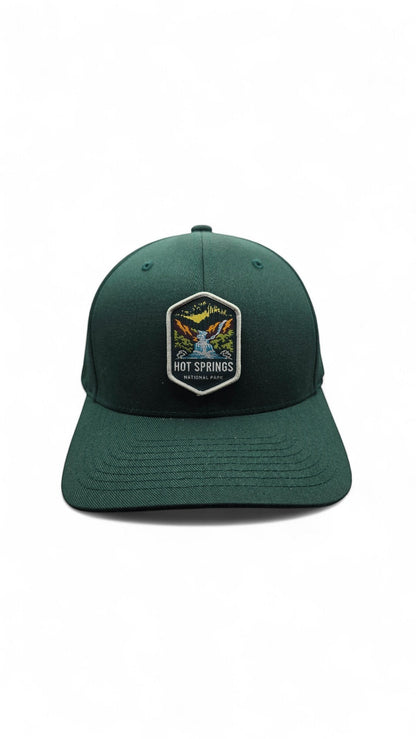 Moove Headwear dark green fitted baseball cap with embroidered Hot Springs National Park patch.