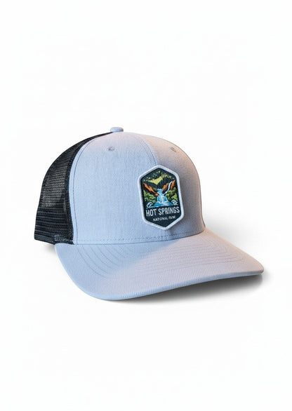 Moove Headwear light blue trucker hat with black mesh back and Hot Springs National Park patch.