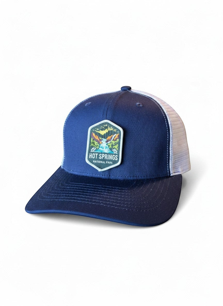 Moove Headwear navy blue trucker hat with white mesh back and Hot Springs National Park patch.